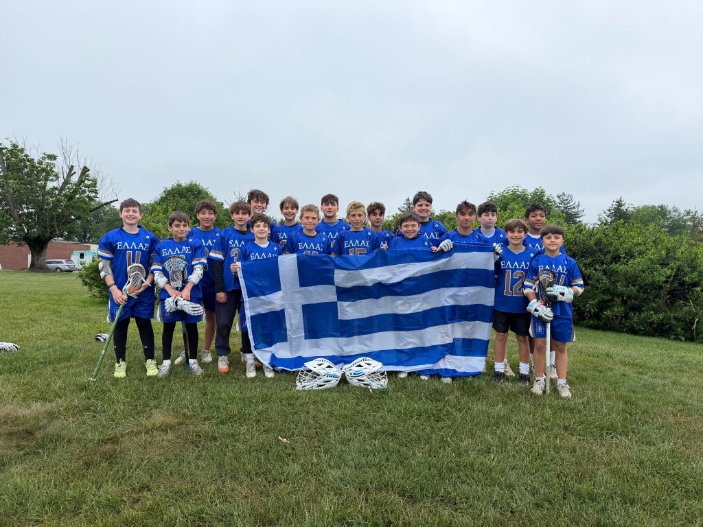 Under 13s Youth Greece Lacrosse team holding a Greek flag