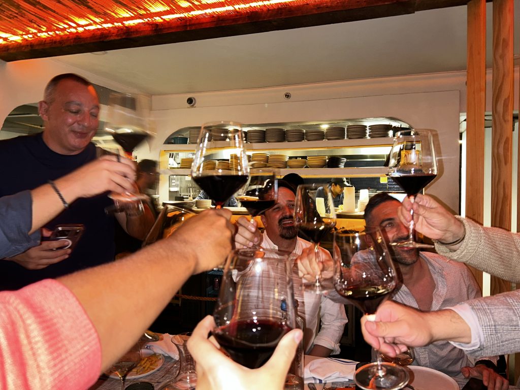 Guests making toast wine dinner Psaraki