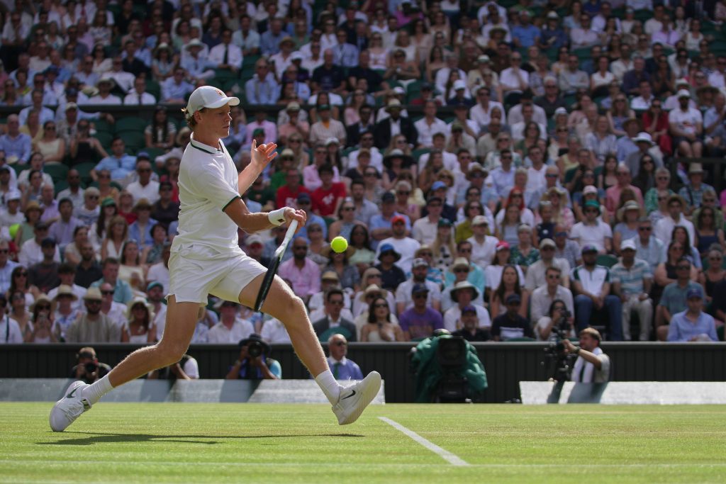 Jannik Sinner of Italy returns the ball to Novak Djokovic of Serbia in their men's singles semifinal match at the Wimbledon Tennis Championships in London, Friday, July 10, 2026. (AP Photo/Brian Inganga)