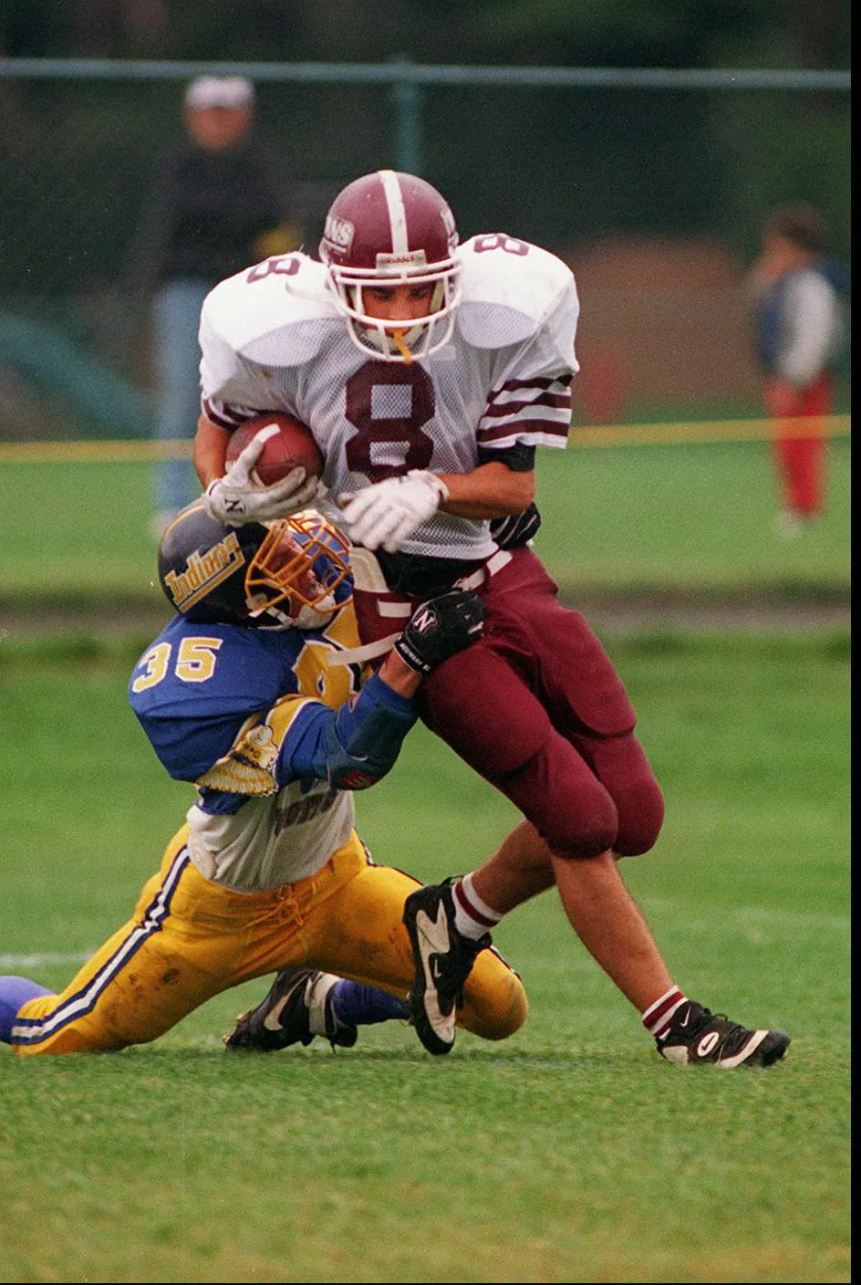 Greece Arcadia's Damon Plumeri (8) struggles to break fee from Irondequoit's Rick Wallenhost during a game on Oct. 1, 1994.