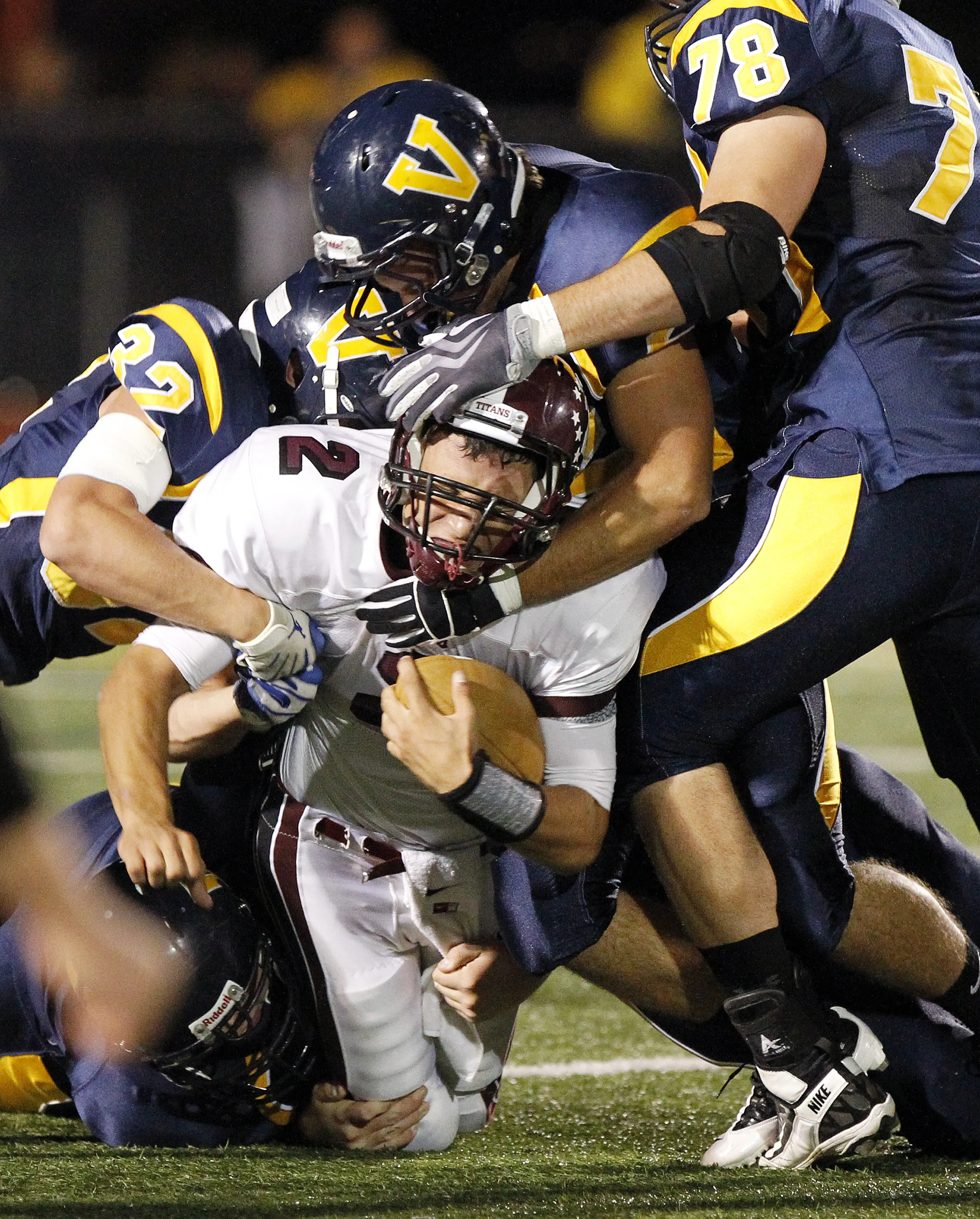 Arcadia's Gio Pannoni (2) tries to bull his way through the Victor defense for some extra yardage during a game in 2011.