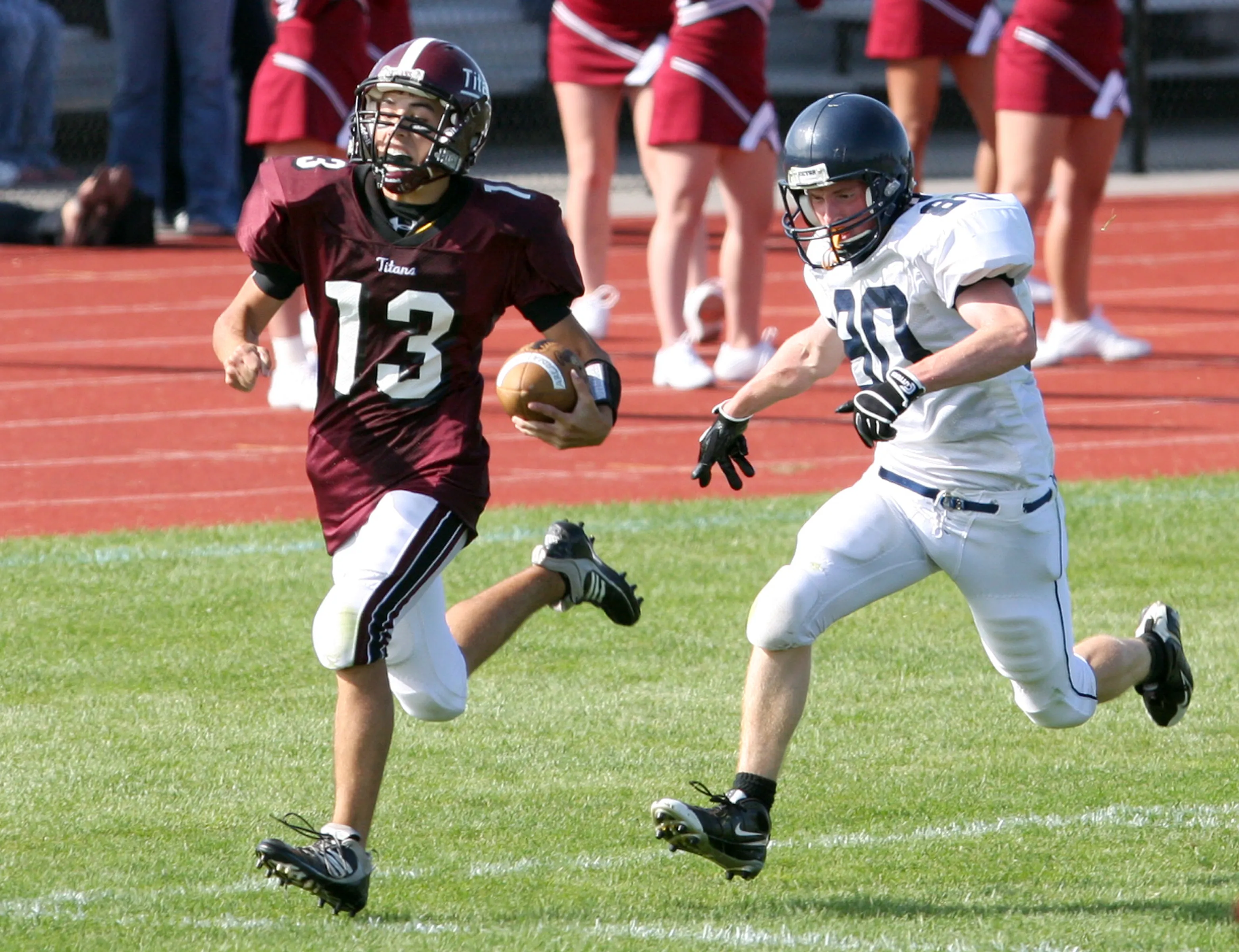 Greece Arcadia quarterback Joshua Hotchkiss (13) scampers 80-yards ahead of Victor's Zac Hess for a touchdown on Sept. 12, 2009.