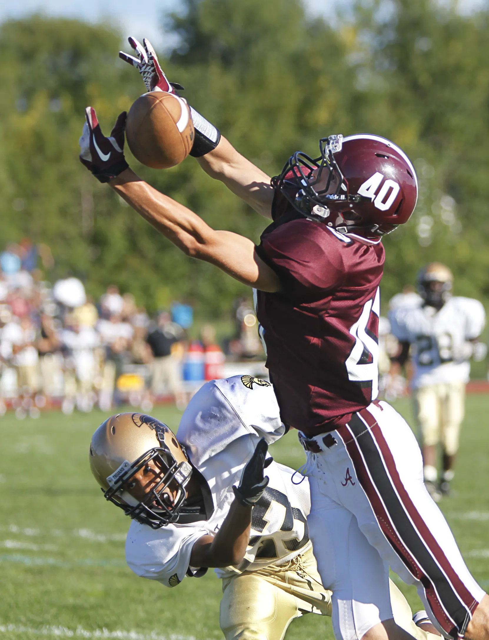 Greece Athena's Tommy Love pushes Greece Arcadia's Mike Defone as he reaches for a pass in the fourth quarter of a 2011 game at Arcadia.