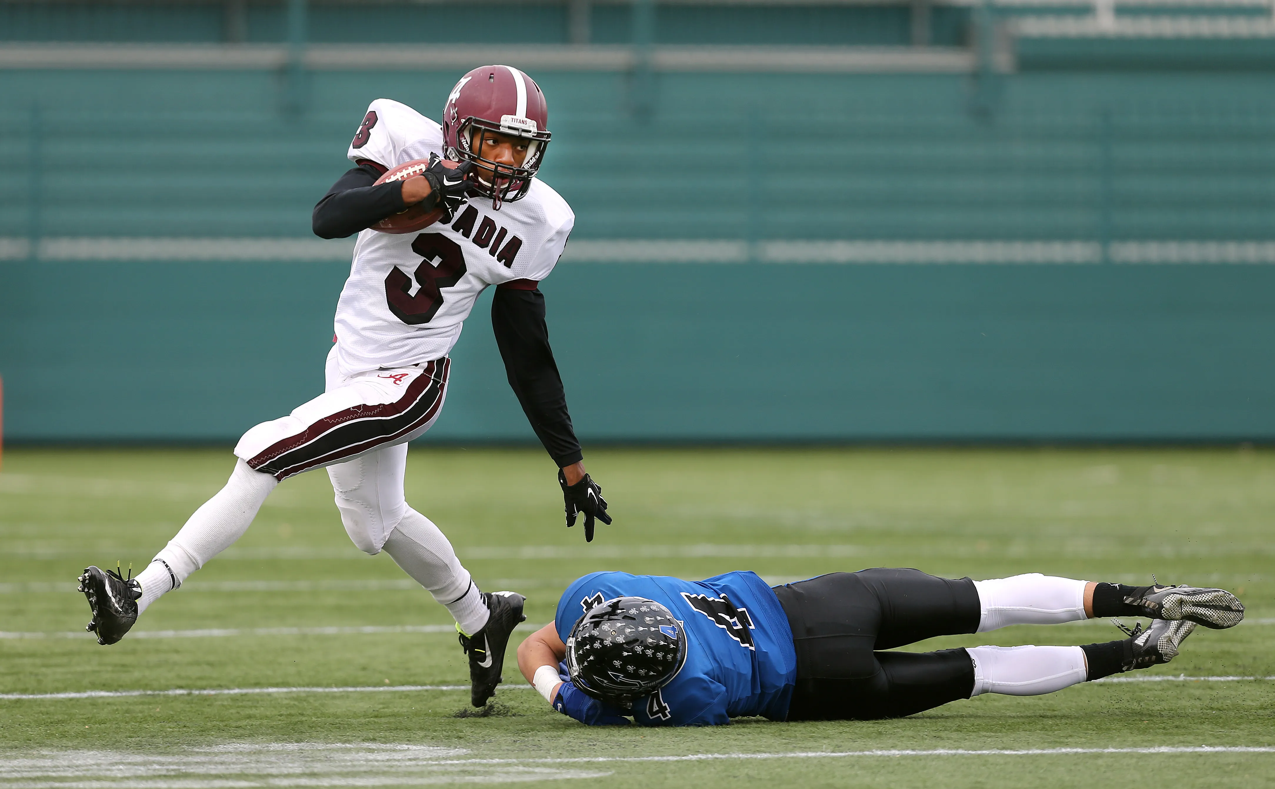 Arcadia's Xavier McGee (3) gets around Brockport's Shane Hogan (4).
