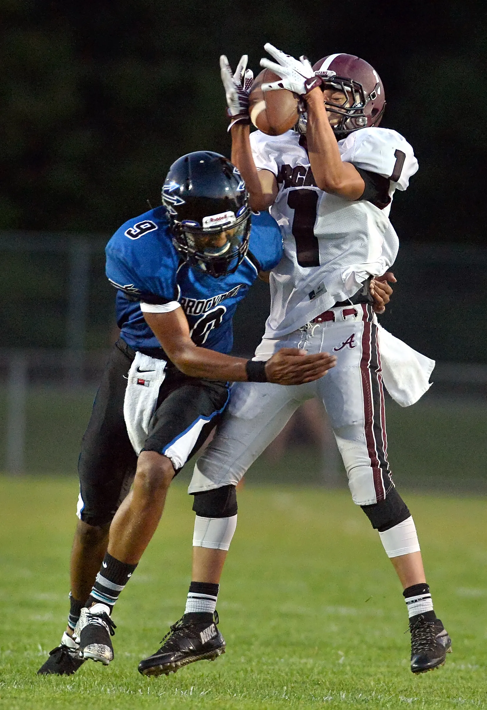 Greece Arcadia's Brandon Barnhart, right, makes a catch while defended by Brockport's Raphael Odey during a game played on Sept. 4, 2015.