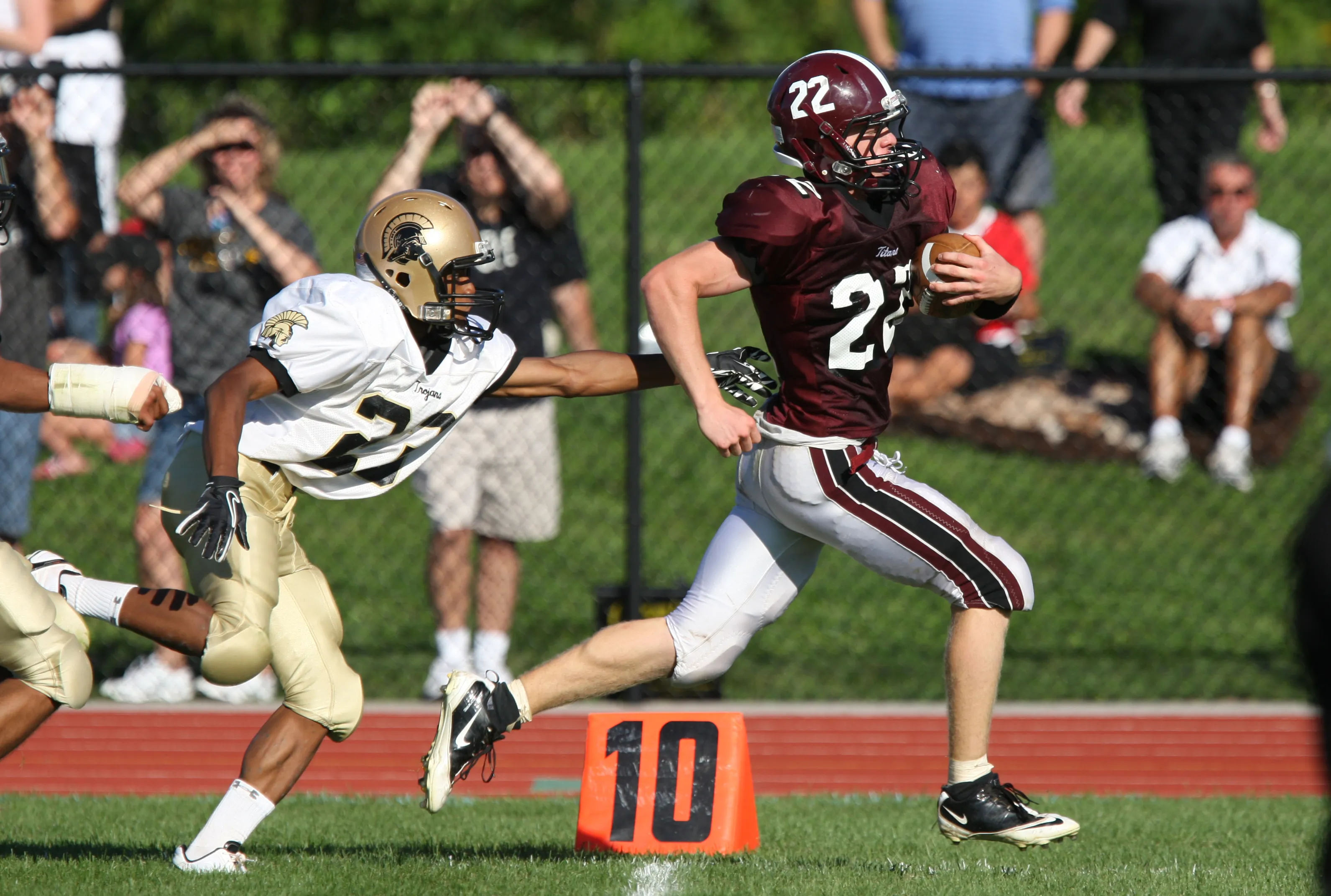 Greece Athena's Tommy Love chases Greece Arcadia's Dave Van Auker down the sideline during a game on Sept. 10, 2011.