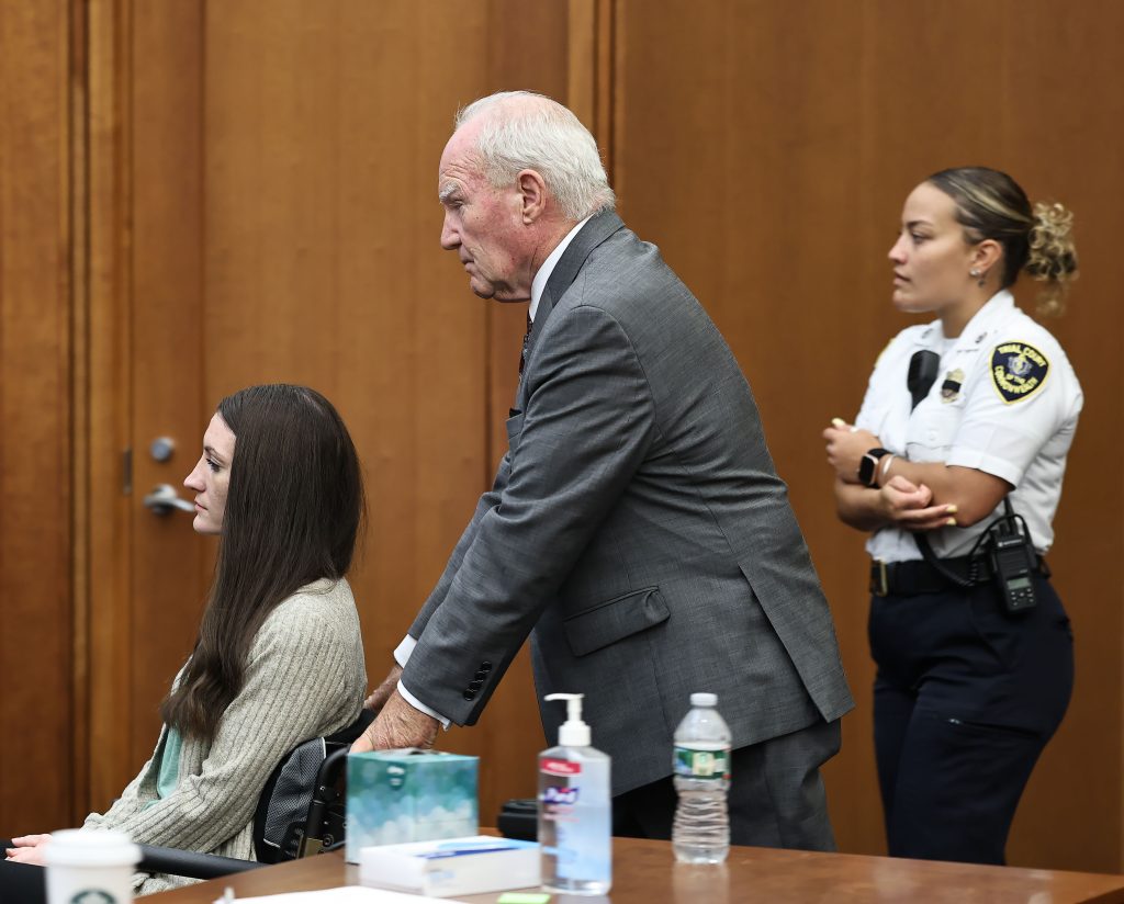 Defense attorney Kevin Reddington pushes the wheelchair of Lindsay Clancy for a sidebar with the judge during her trial in Plymouth, Mass., on Thursday, Sept. 3, 2026.